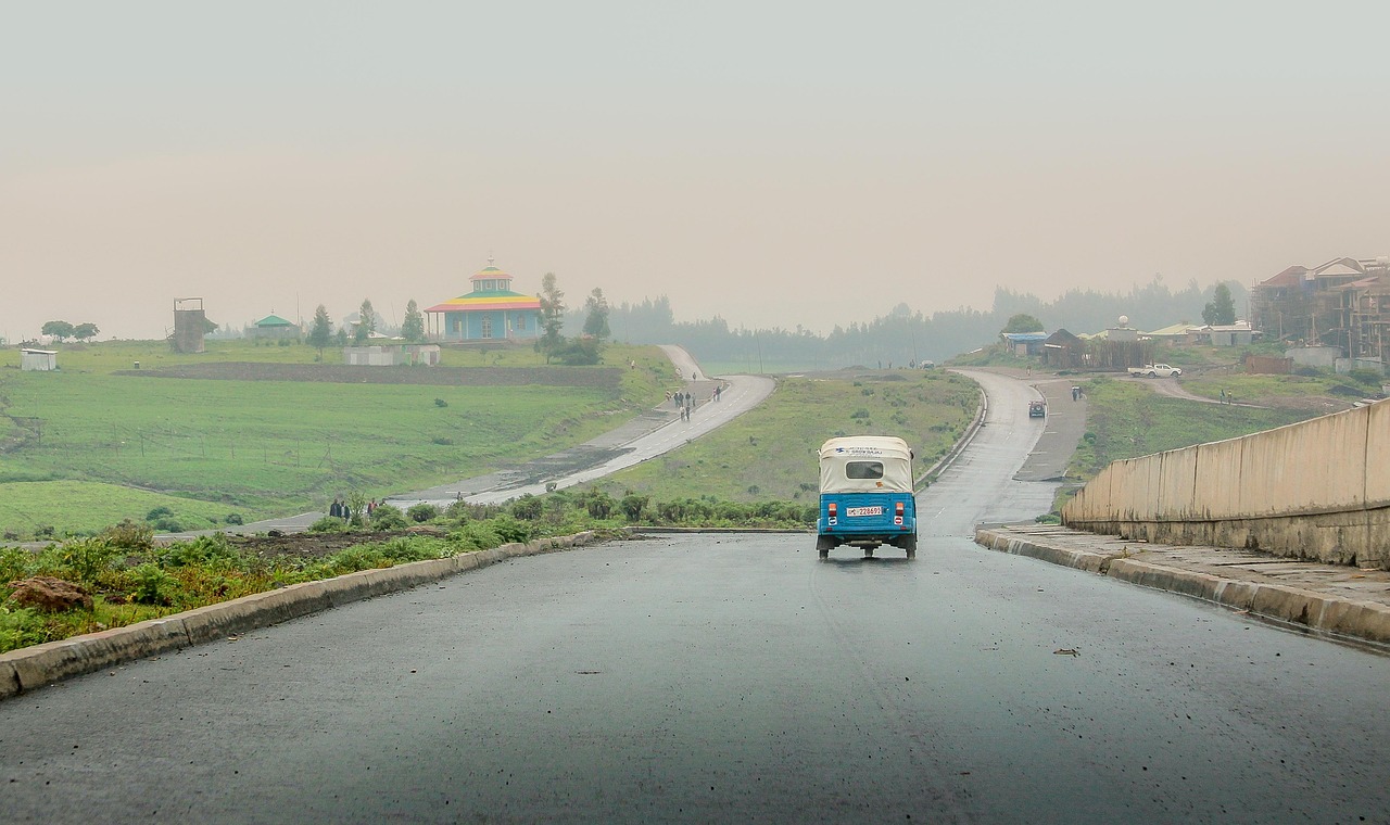 Tricycle, road, hills, wet road, street, lane, pavement, avenue, vehicle, transportation, addis ababa, ethiopia, orthodox church, africa, rain, rainy, rainy weather, landscape, nature, fields, addis a