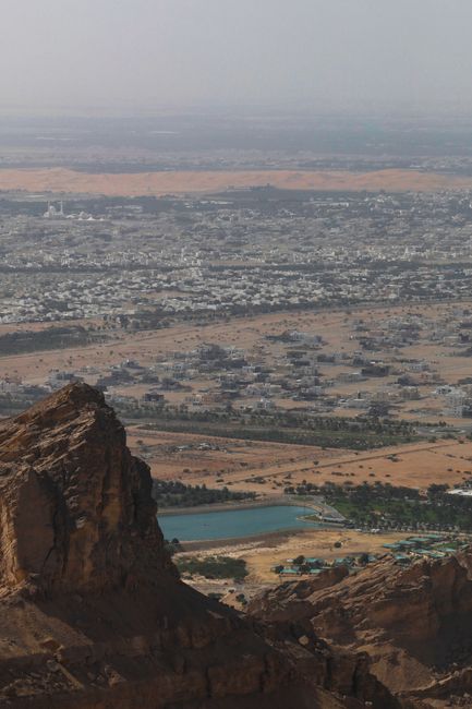 A breathtaking aerial shot capturing a desert cityscape with rocky mountains and plains.