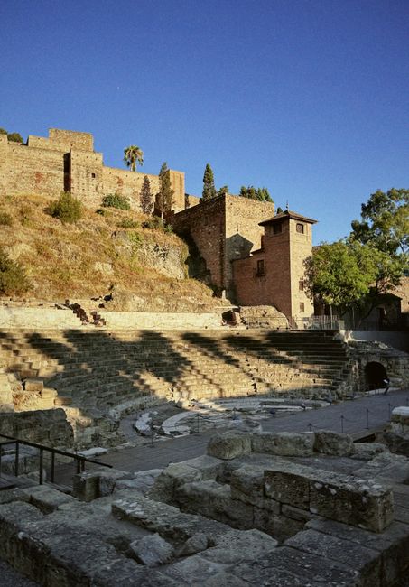 Explore the historic Roman theater ruins and Alcazaba in Málaga, Spain at sunset.