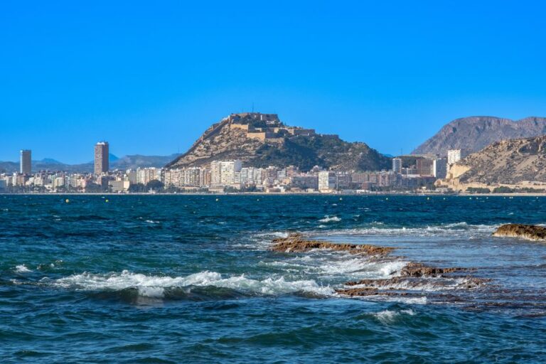 Picturesque view of Alicante's coastline with the iconic Santa Bárbara Castle on a sunny day.