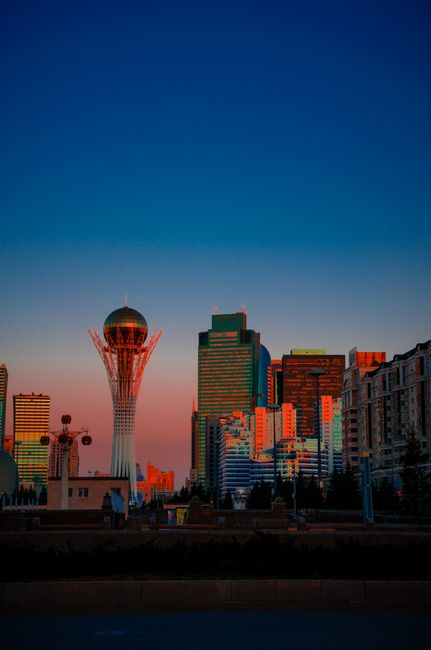 Stunning view of Astana's skyline featuring the iconic Baiterek Tower at sunset.