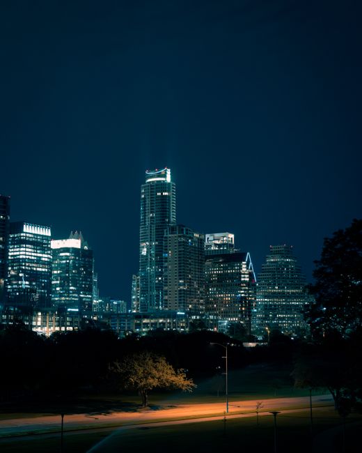 Illuminated Austin skyline showcasing vibrant skyscrapers against the night sky.