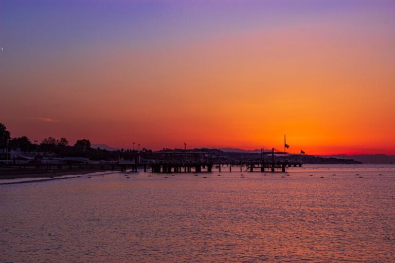 Captivating sunset over Belek Beach in Antalya, featuring a serene ocean view and vibrant sky.