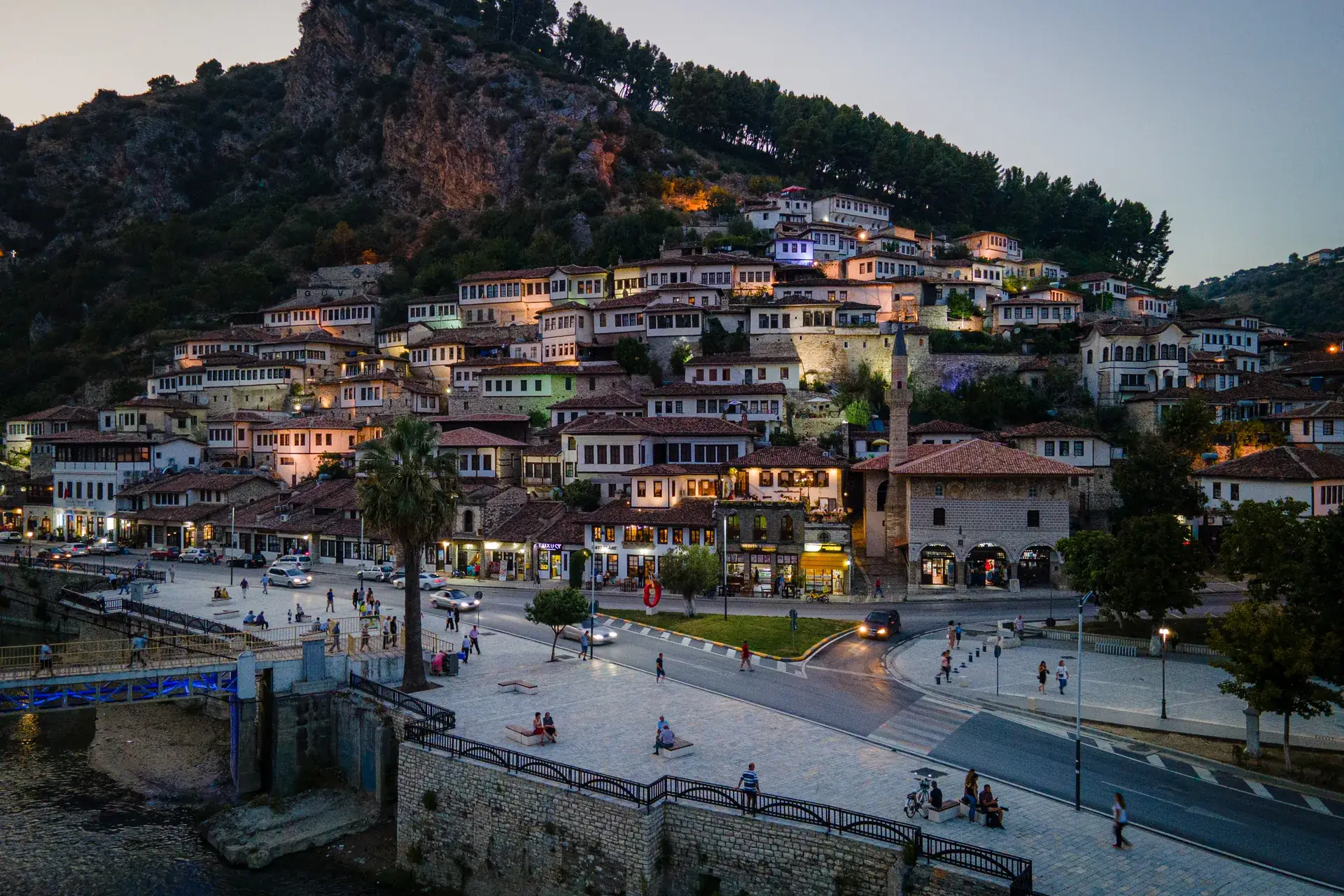 The white Ottoman houses of Berat climbing the hill above the Osum River at dusk, Albania