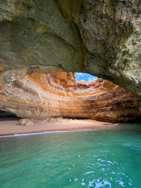 Beautiful coastal cave at Praia de Benagil, Algarve with turquoise water and sandy beach.