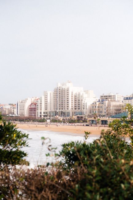 A serene view of Biarritz's beachfront and urban architecture on a sunny day.