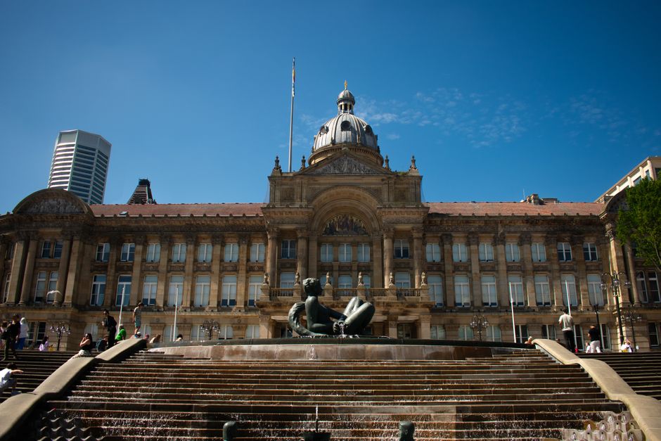 Stunning view of Birmingham Council House with clear sky and fountain in the foreground, capturing architectural elegance.