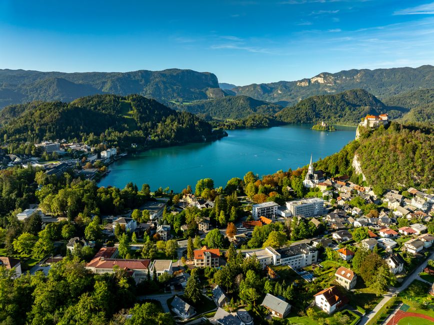 Stunning aerial view of Lake Bled with vibrant landscape and the town of Bled in Slovenia on a sunny day.