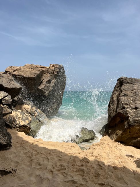 Waves crashing on rocky beach at Boa Vista, Cabo Verde. Perfect for travel and adventure themes.