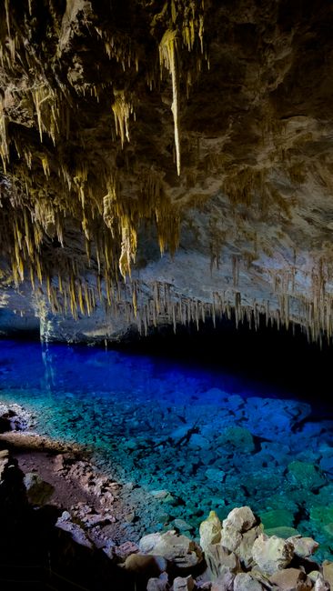 Stunning stalactites and vibrant blue lagoon in Gruta do Lago Azul Cave, Brazil.