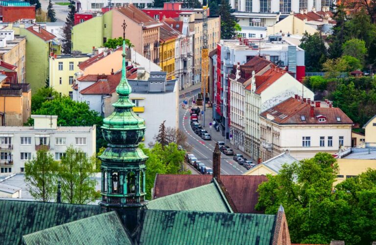 Aerial view of the colorful cityscape of Brno, highlighting its green tower and gothic architecture.