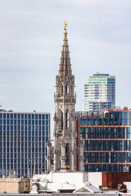 View of Brussels skyline with the historic Town Hall tower amidst modern buildings.