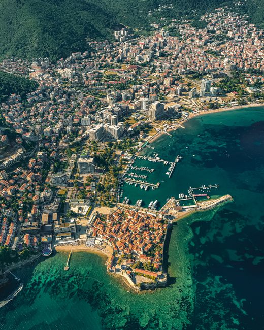 Discover the stunning aerial view of Budva, Montenegro, showcasing its coastline and architecture.