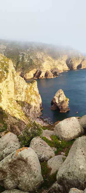 Breathtaking view of Cabo da Roca cliffs in Sintra, Portugal with rugged rocks and misty ocean.
