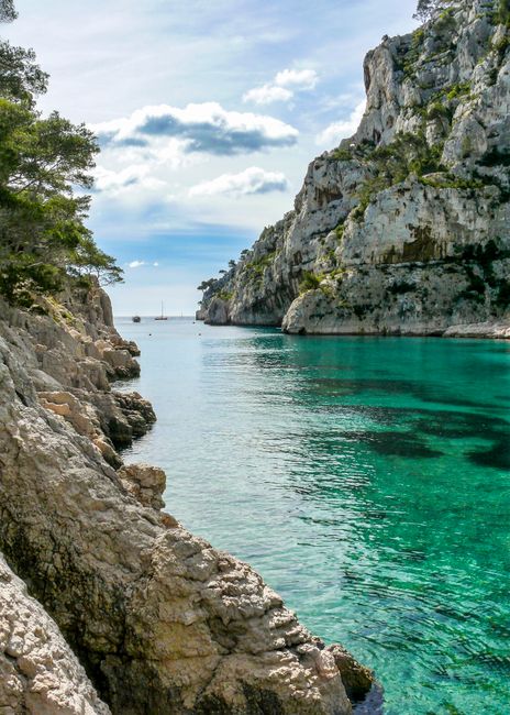 Explore the stunning calanque in Marseille, France, with its clear turquoise waters and majestic cliffs.