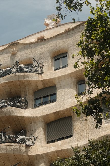 Architectural detail of Gaudí's La Pedrera in Barcelona, featuring its unique curves and ironwork balconies.