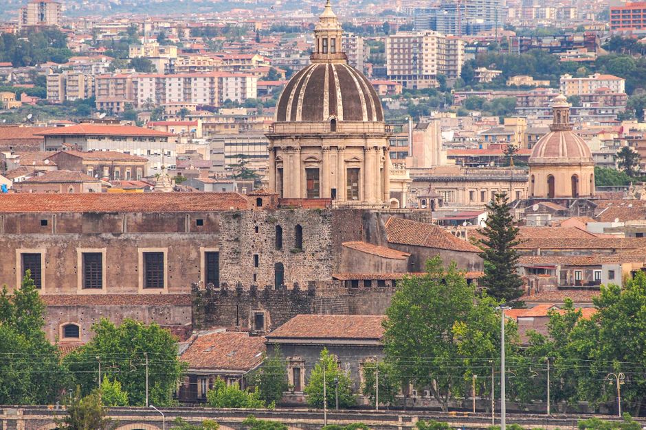 Panoramic view of Catania's historic architecture featuring domes and cityscape.