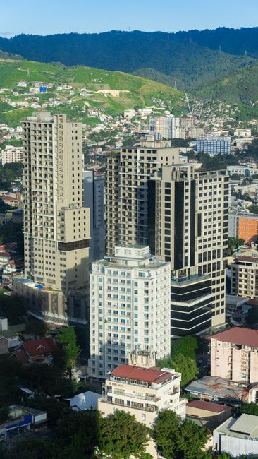 A vibrant aerial view of tall skyscrapers in Cebu City, Central Visayas, Philippines, under clear skies.