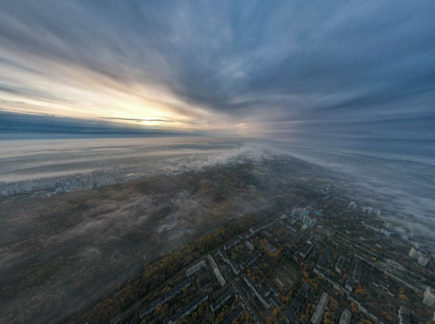 Breathtaking aerial view of Chișinău, Moldova at sunrise. Cityscape shrouded in mist and clouds.