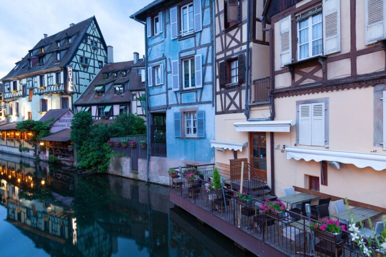 Picturesque view of traditional half-timbered houses along the canal in Colmar, France.