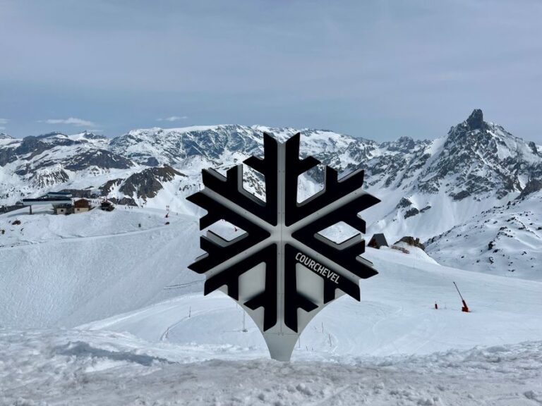 Snow-covered mountains at Courchevel sign, perfect for winter sports and scenic views.