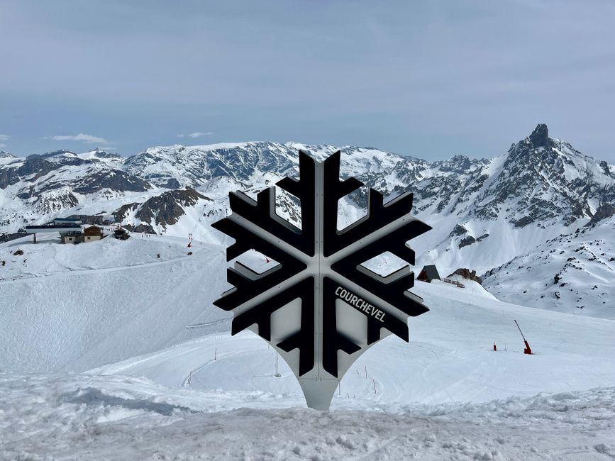 Snow-covered mountains at Courchevel sign, perfect for winter sports and scenic views.