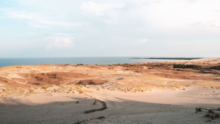 Breathtaking view of the Curonian Spit sand dunes meeting the Baltic Sea.