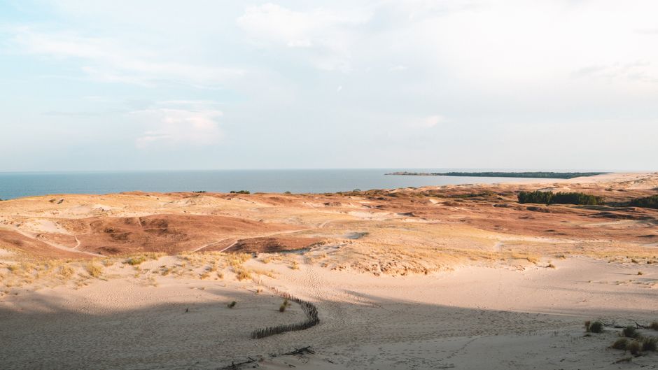 Breathtaking view of the Curonian Spit sand dunes meeting the Baltic Sea.
