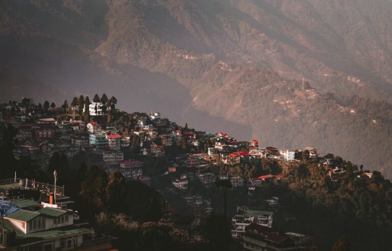 Aerial view of Darjeeling with vibrant houses nestled in the verdant hills of West Bengal, India.