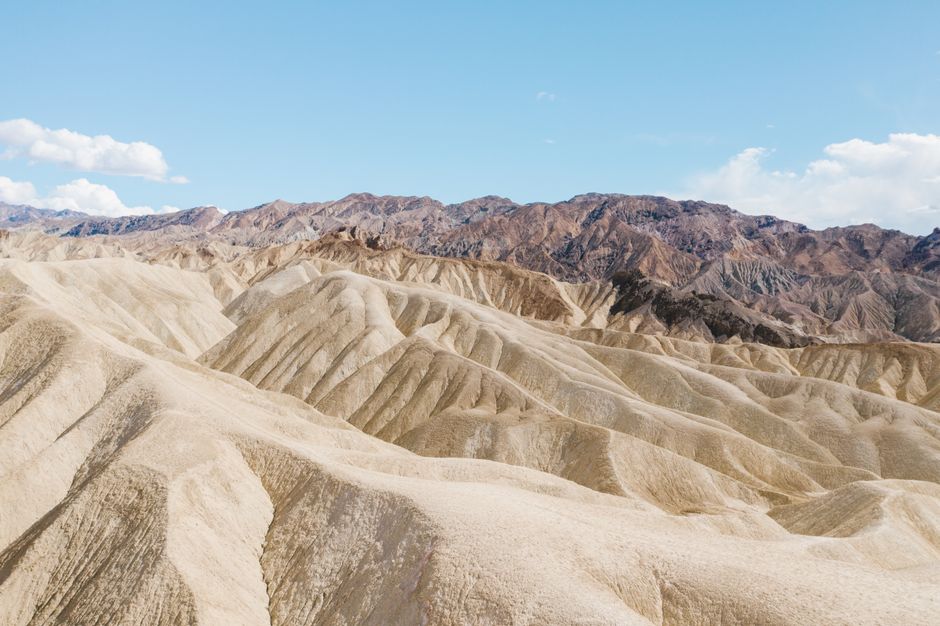 Beautiful eroded desert landscape of Death Valley National Park under a clear blue sky.