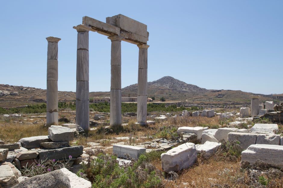 Explore the ancient ruins and historical architecture on the island of Delos in Greece.