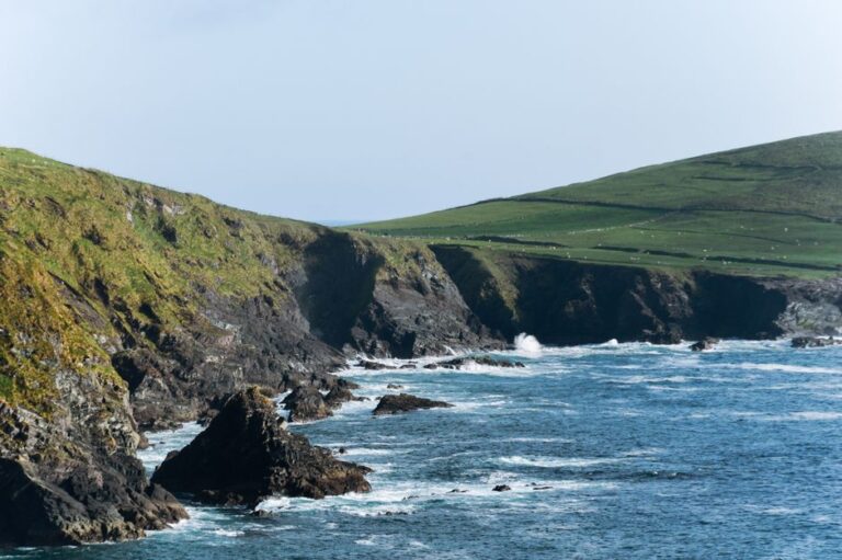 Stunning view of rugged cliffs and ocean waves along the Kerry coastline in Ireland.