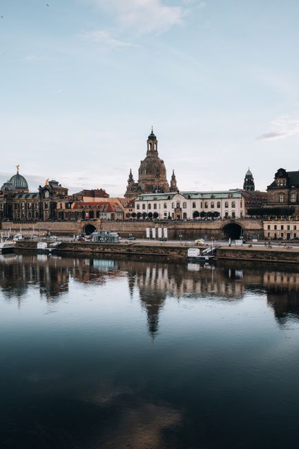 Stunning view of Dresden's iconic architecture reflecting in the Elbe River during daytime.