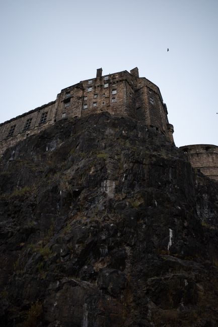 Stunning perspective of Edinburgh Castle perched on its rocky cliffside, showcasing architectural grandeur.