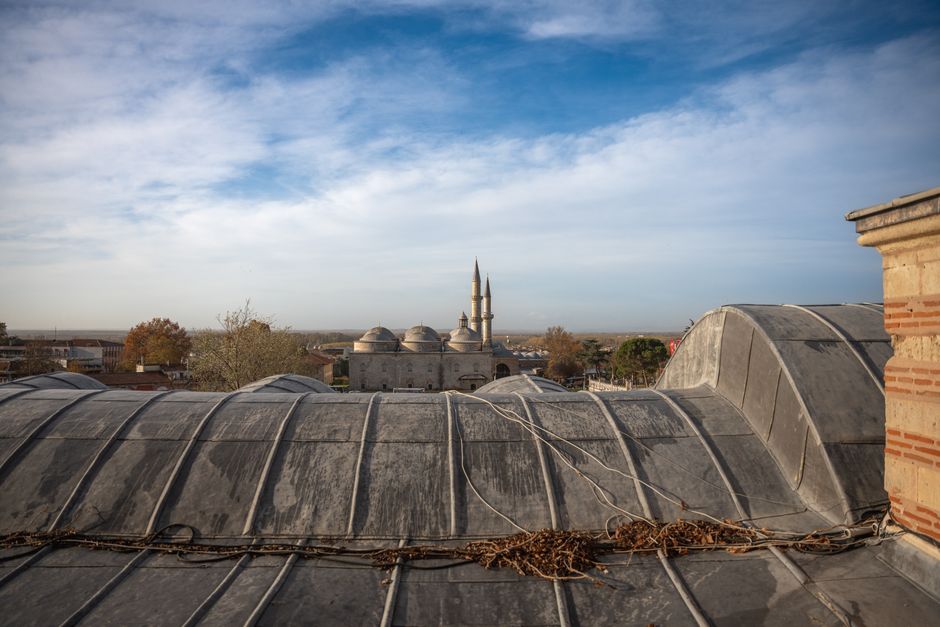 A breathtaking view of traditional roofs and minarets against a clear blue sky in Edirne, Turkey.