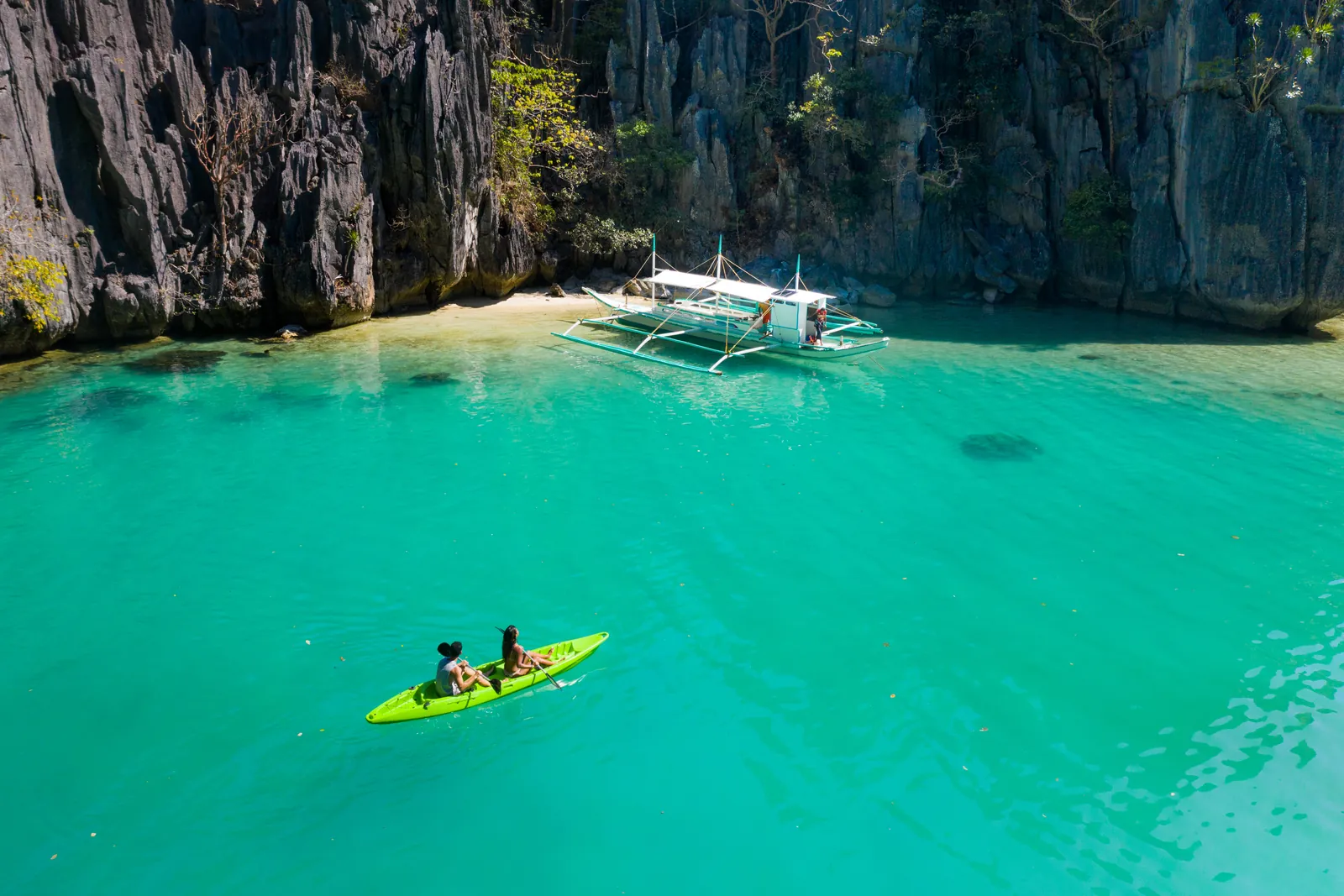 A kayak on the clear turquoise water of a beach in El Nido, Palawan, Philippines