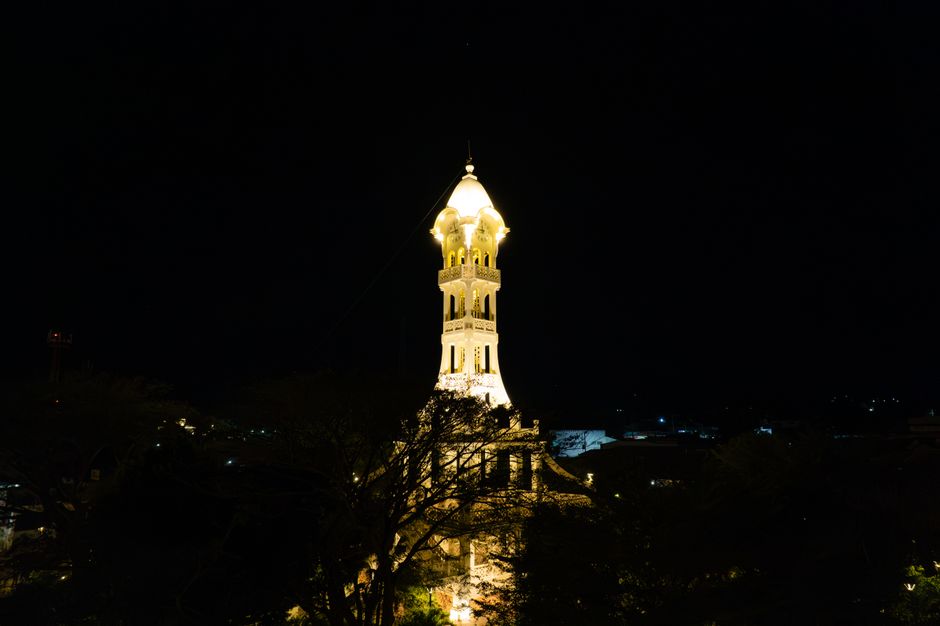 Stunning night shot of the illuminated tower in San Vicente, El Salvador, showcasing its architectural beauty.