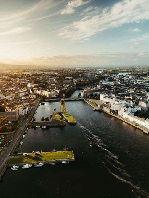 Stunning aerial view of Limerick cityscape by the River Shannon during a beautiful sunset.