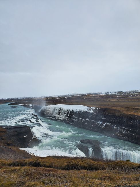 Discover the stunning Gullfoss waterfall in Iceland's winter landscape.
