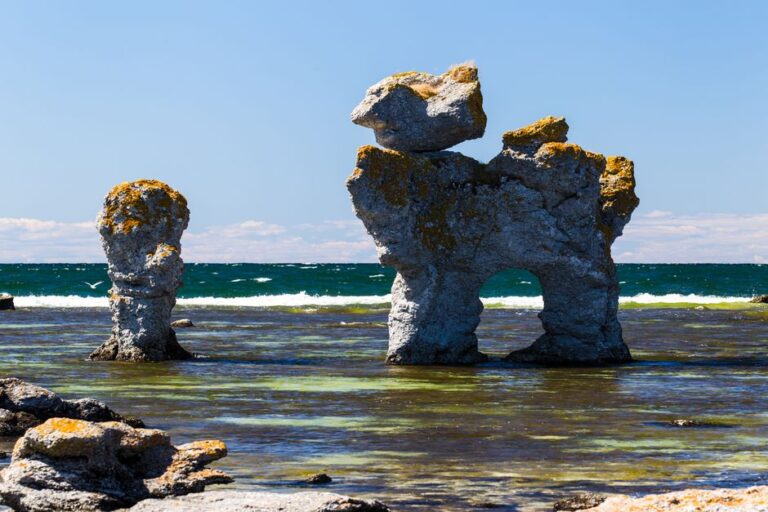 Explore the unique sea stacks of Gotland, Sweden, on a sunny summer day by the beach.