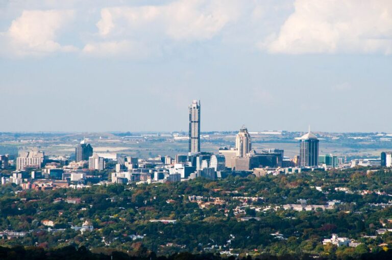 Aerial view of Sandton's skyline in Gauteng, South Africa, with a clear blue sky.