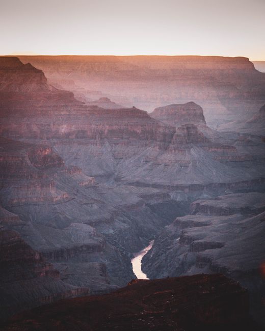 Breathtaking view of the Grand Canyon at sunset, featuring the winding Colorado River.
