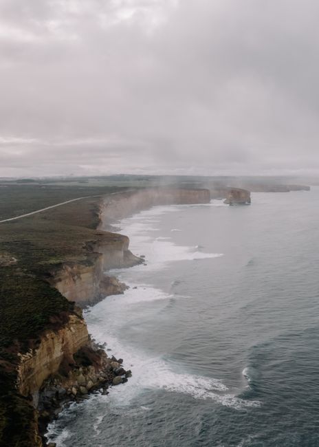 Aerial view of the scenic and rugged cliffs along the coast of Anglesea, VIC, Australia under overcast skies.