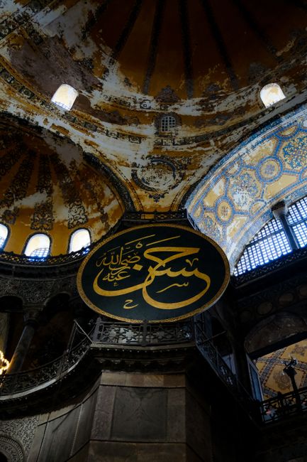 Stunning view of the ornate dome and Arabic inscriptions inside Hagia Sophia, Istanbul.