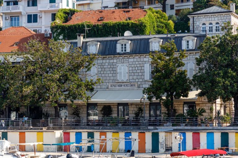 Picturesque view of a historic building by the waterfront in Herceg Novi, Montenegro.