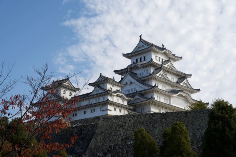 Himeji Castle, a UNESCO World Heritage Site, under a clear blue sky, showcasing traditional Japanese architecture.