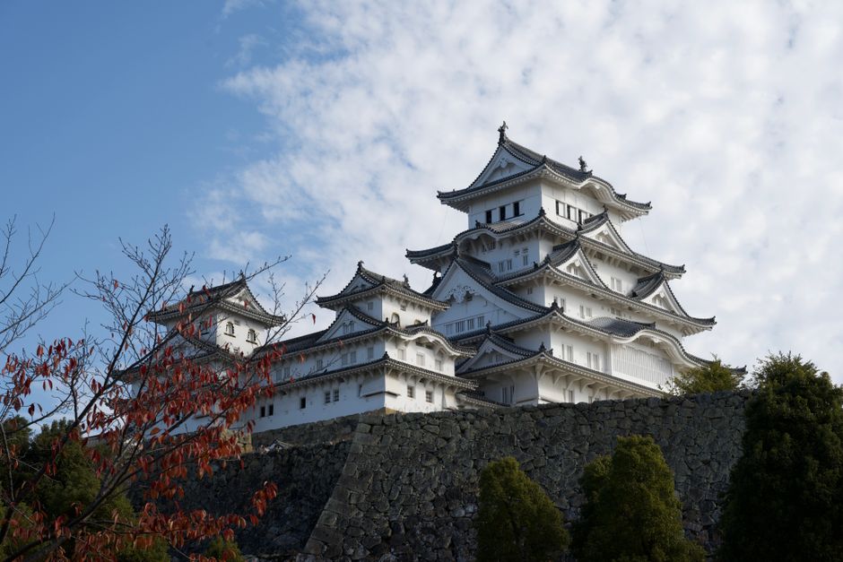 Himeji Castle, a UNESCO World Heritage Site, under a clear blue sky, showcasing traditional Japanese architecture.