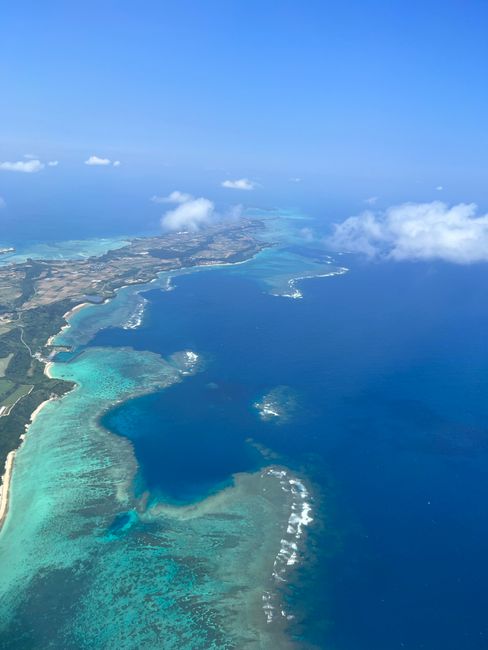 Stunning aerial view of Okinawa's turquoise waters and coastal landscape.