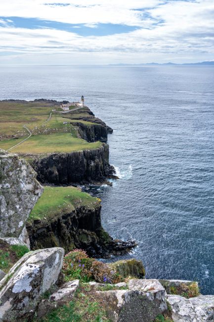 Stunning view of Scottish cliffs and Neist Point Lighthouse overlooking the ocean.