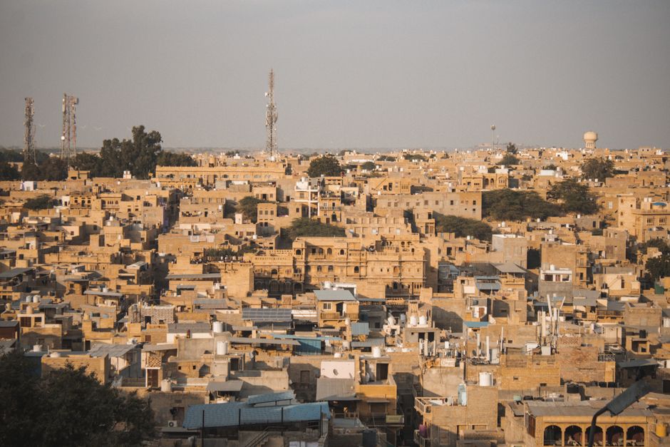 Aerial view of the historic sandstone architecture in Jaisalmer, Rajasthan, India under the warm daylight.